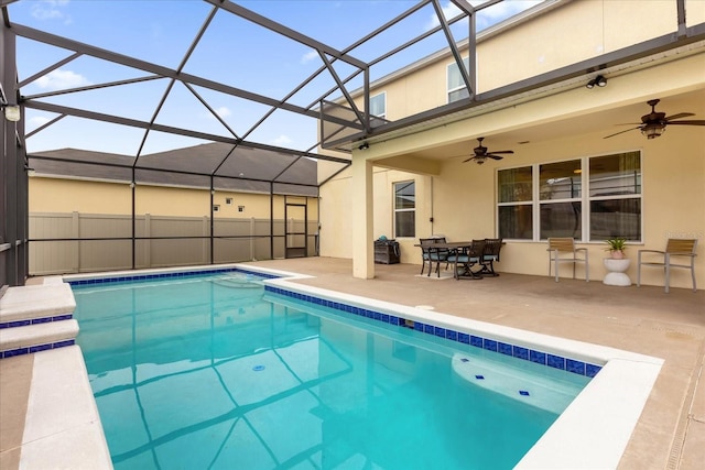 view of pool featuring a patio area, ceiling fan, and a lanai