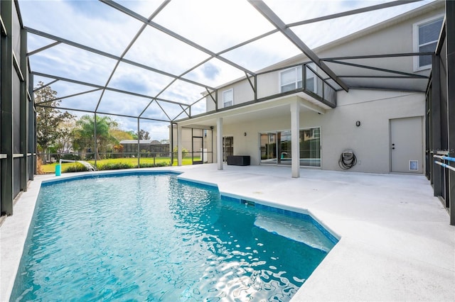 view of pool featuring glass enclosure and a patio