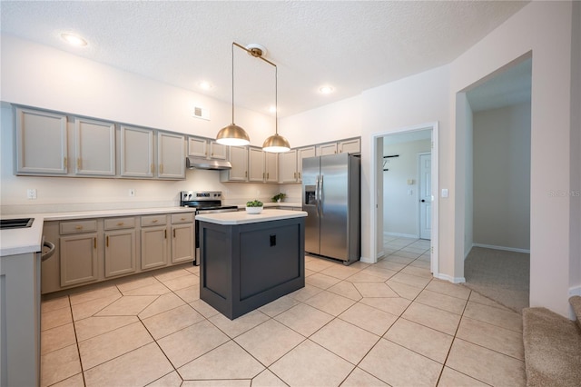 kitchen featuring gray cabinetry, stainless steel appliances, light tile patterned floors, a kitchen island, and hanging light fixtures