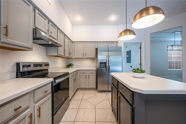 kitchen with a center island, gray cabinets, light tile patterned floors, appliances with stainless steel finishes, and decorative light fixtures