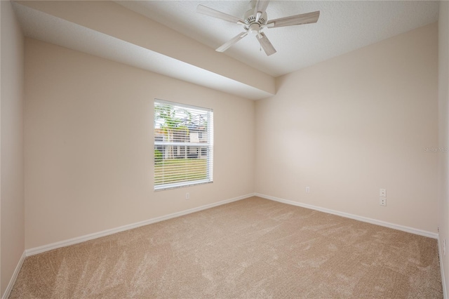 carpeted empty room featuring ceiling fan and a textured ceiling