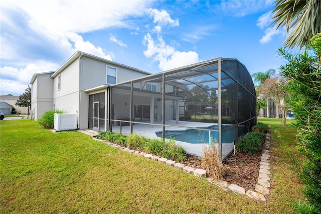 rear view of property featuring a lanai and a yard