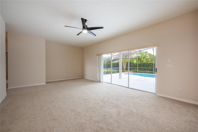 spare room featuring ceiling fan, light carpet, and a textured ceiling