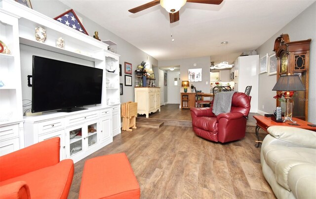 living room with light hardwood / wood-style floors and ceiling fan