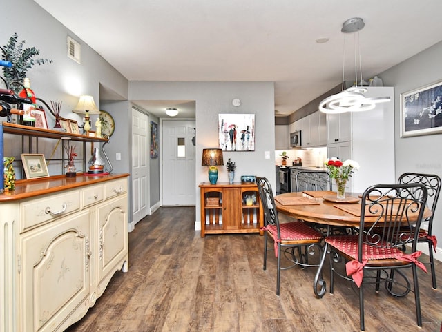 dining area featuring dark hardwood / wood-style floors