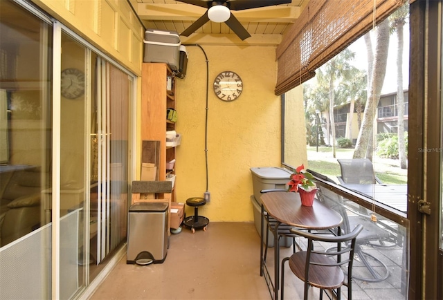 sunroom / solarium featuring ceiling fan