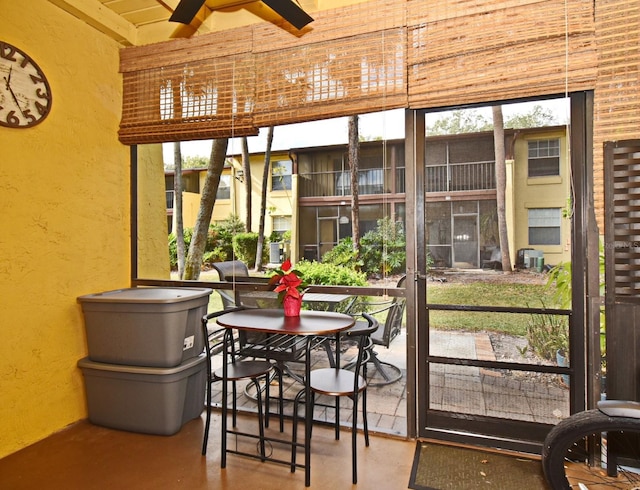 sunroom / solarium with beamed ceiling and a healthy amount of sunlight