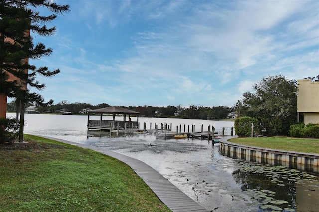 view of dock featuring a lawn and a water view