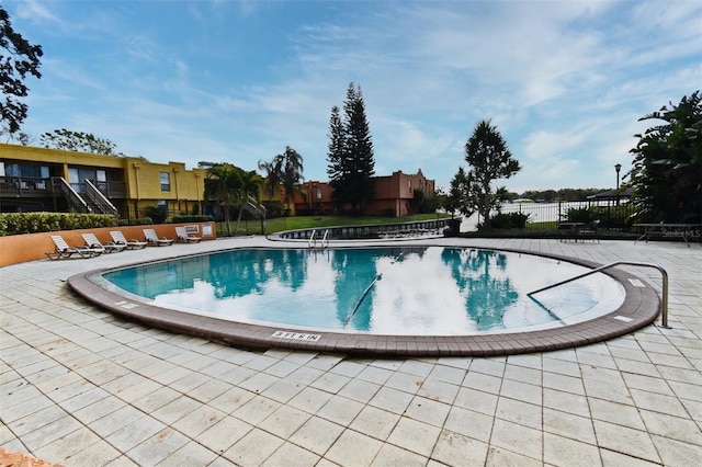 view of swimming pool featuring a patio area