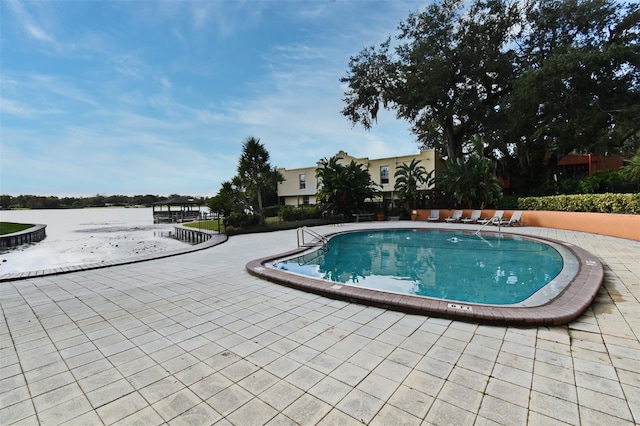 view of pool with a water view