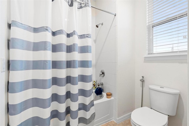 bathroom with toilet and shower / tub combo