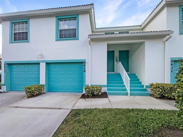 6629 Pineview Ter Unit 5-201, Bradenton, FL 34203 - view of front of house featuring stucco siding, concrete driveway, and a garage