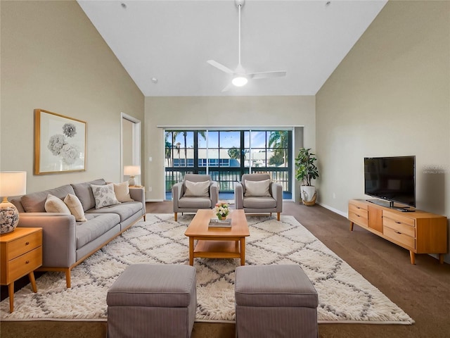 living room with ceiling fan, dark carpet, and high vaulted ceiling