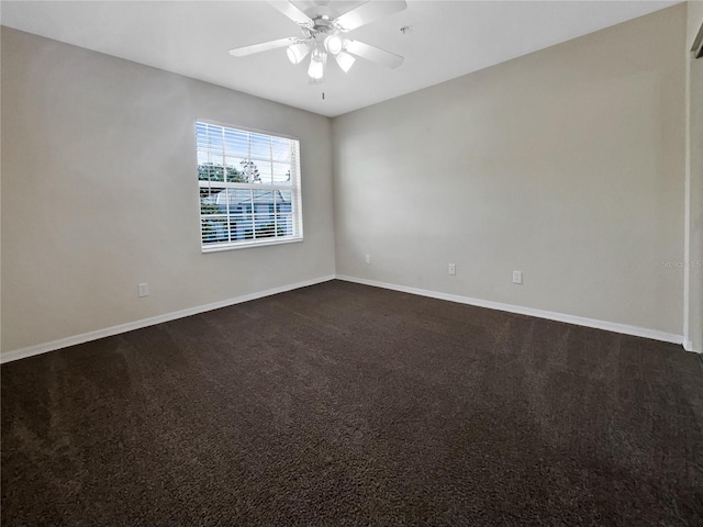 empty room featuring ceiling fan and dark colored carpet