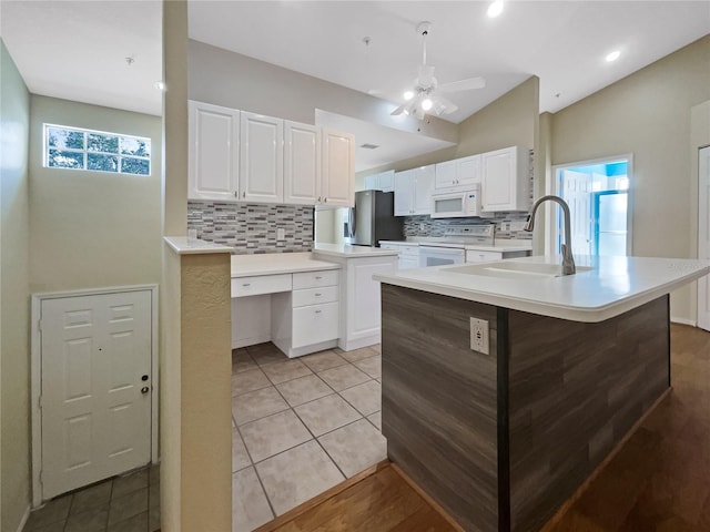 6629 Pineview Ter Unit 5-201, Bradenton, FL 34203 - kitchen with white appliances, backsplash, white cabinetry, ceiling fan, and light countertops