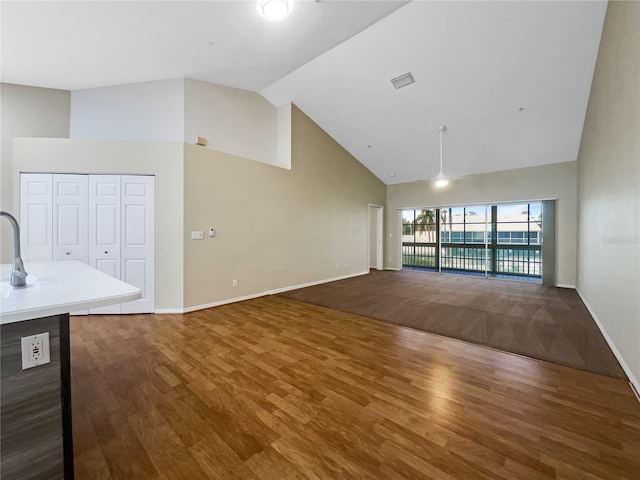 6629 Pineview Ter Unit 5-201, Bradenton, FL 34203 - unfurnished living room with high vaulted ceiling and wood finished floors