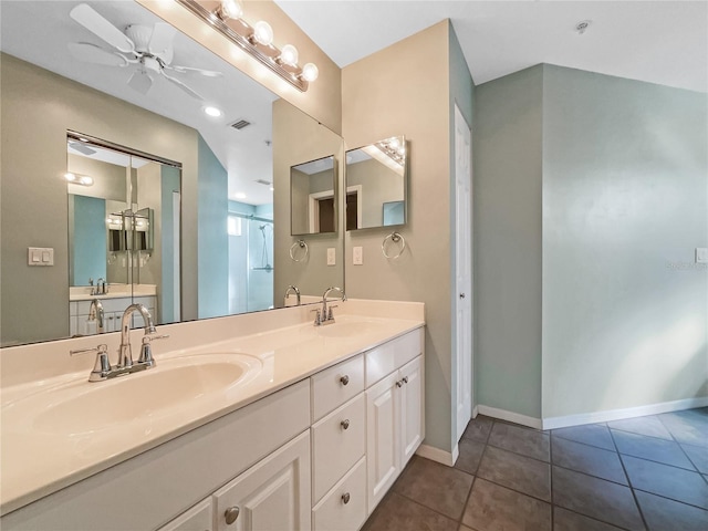 bathroom featuring tile patterned floors, ceiling fan, a shower with door, and vanity