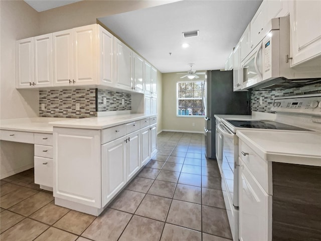6629 Pineview Ter Unit 5-201, Bradenton, FL 34203 - kitchen with white appliances, light tile patterned flooring, white cabinets, and tasteful backsplash