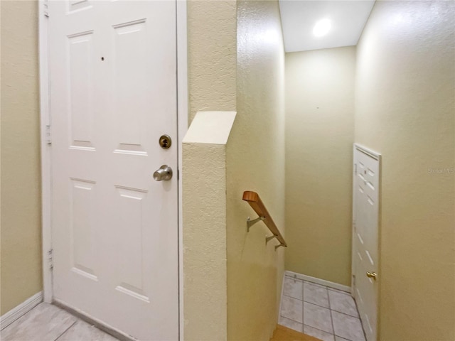 entryway with light tile patterned floors