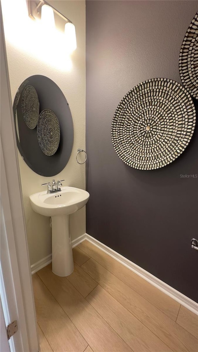 bathroom with hardwood / wood-style flooring