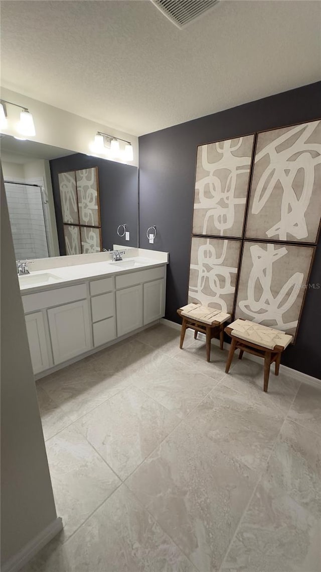 bathroom with vanity and a textured ceiling