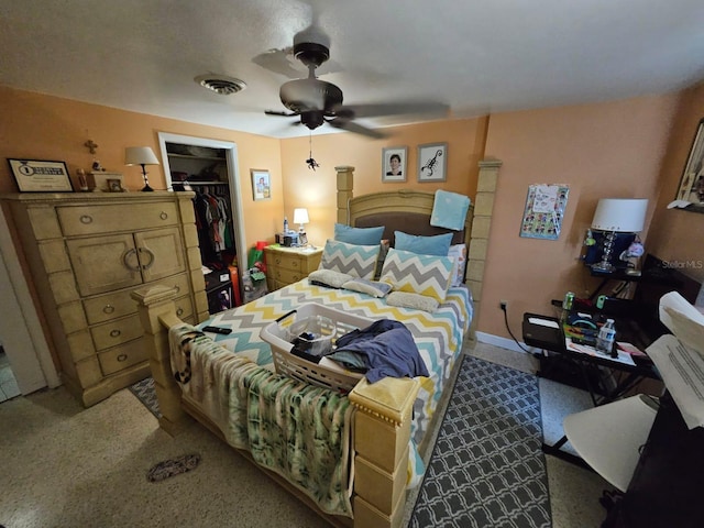 carpeted bedroom with ceiling fan, a spacious closet, and a closet