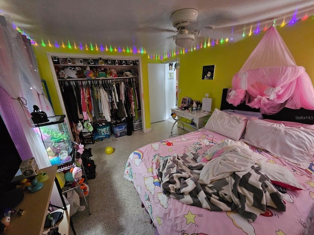 bedroom with ceiling fan and a closet