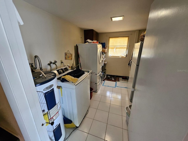 laundry room with separate washer and dryer, electric water heater, and light tile patterned floors