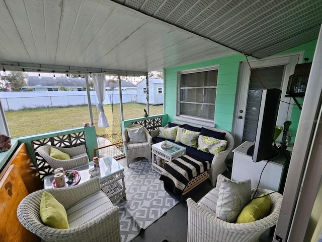 sunroom featuring vaulted ceiling