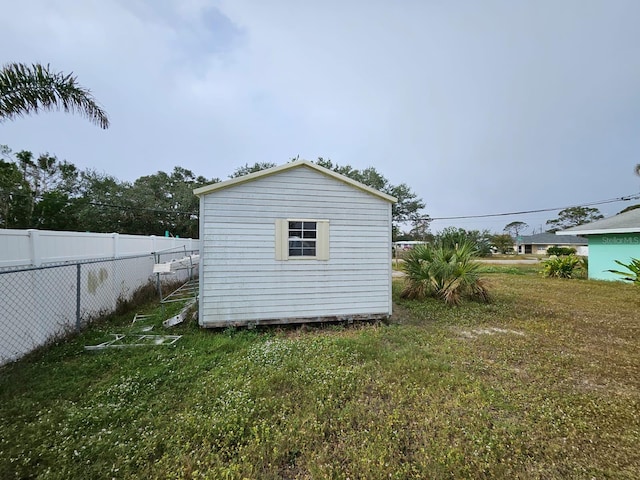 view of property exterior featuring a shed and a yard