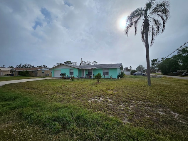 single story home with a garage and a front yard