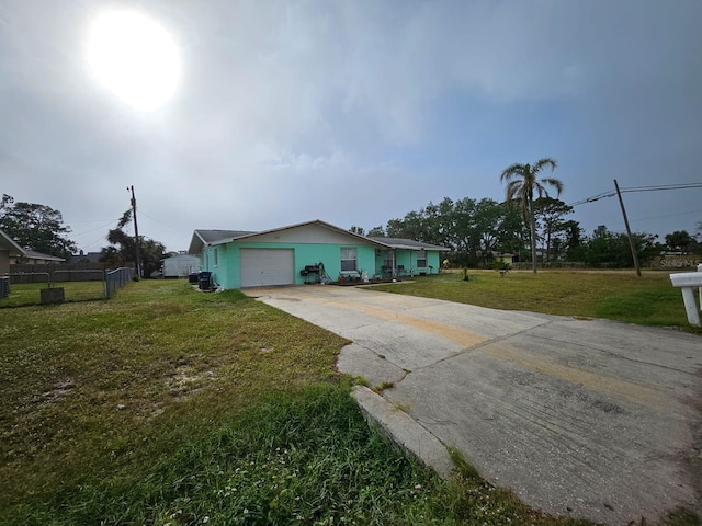 view of front facade with a garage and a front lawn