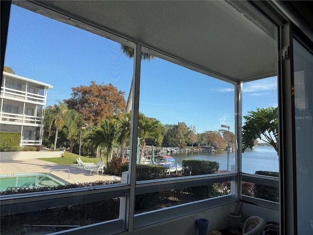 unfurnished sunroom with a wealth of natural light and a water view