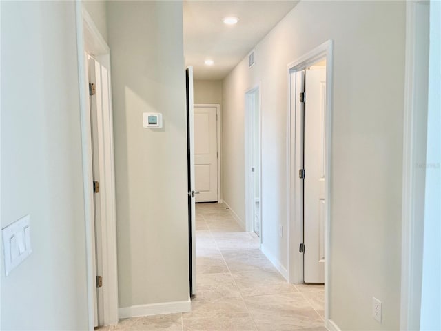 corridor featuring light tile patterned floors