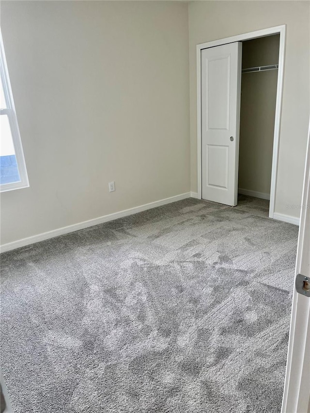 unfurnished bedroom featuring a closet and carpet flooring