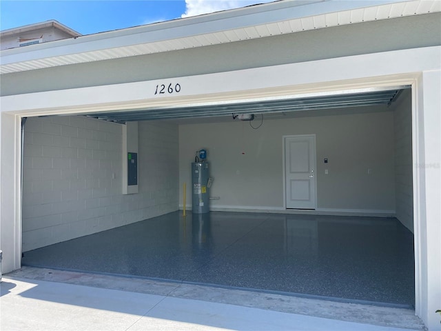 garage with a garage door opener, electric panel, and electric water heater