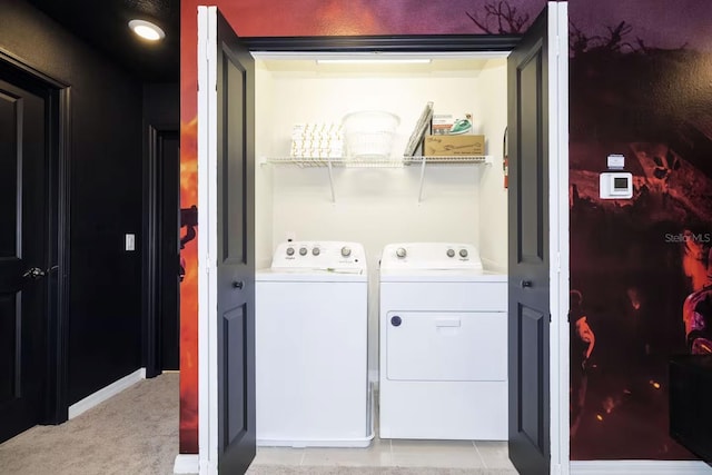 laundry room with light carpet and washer and clothes dryer