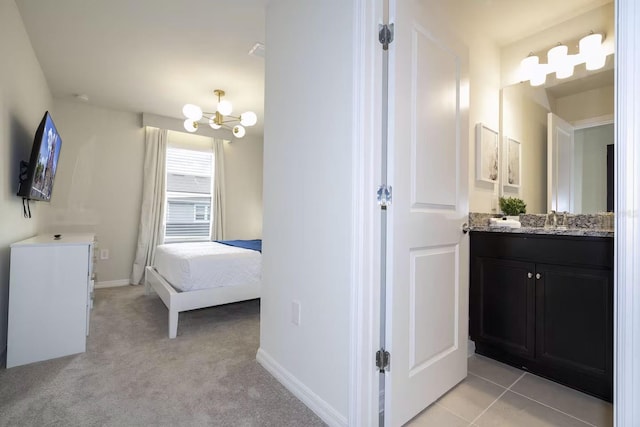 bathroom featuring tile patterned floors, vanity, and a chandelier