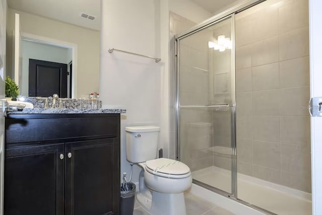 bathroom with tile patterned flooring, toilet, vanity, and walk in shower