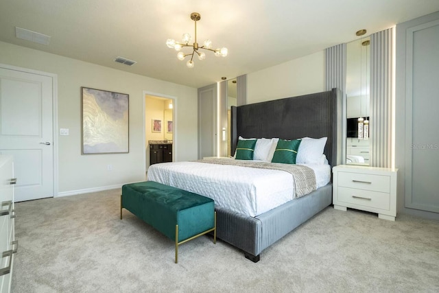 carpeted bedroom with connected bathroom and a notable chandelier