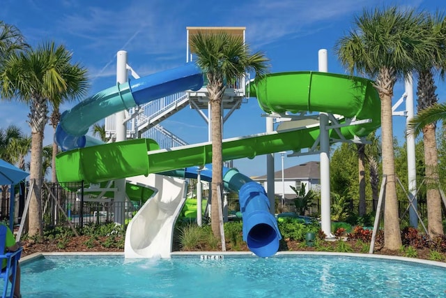 view of swimming pool with a water slide