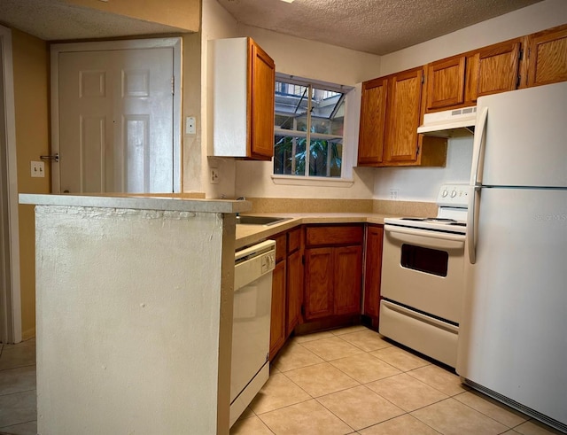 kitchen with white appliances, sink, a textured ceiling, light tile patterned flooring, and kitchen peninsula