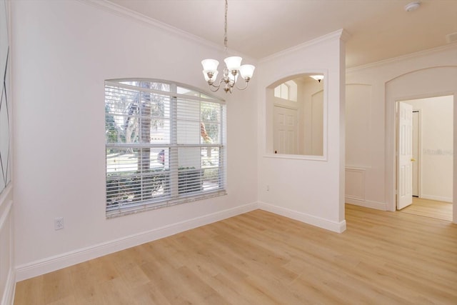 unfurnished dining area featuring a notable chandelier, crown molding, and light hardwood / wood-style floors