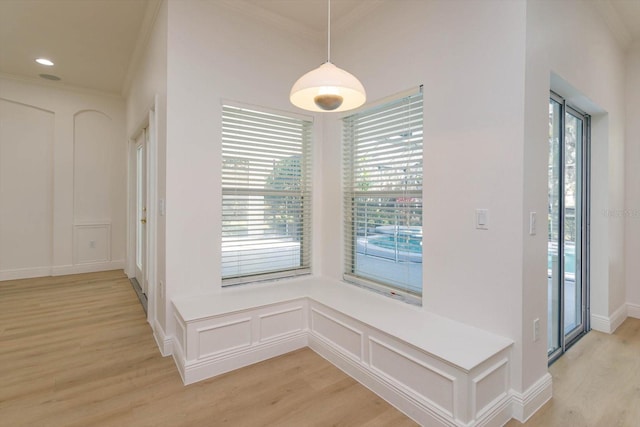 corridor featuring ornamental molding and light wood-type flooring