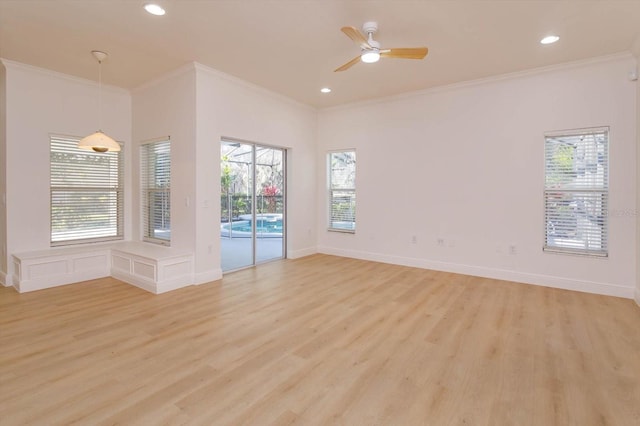 spare room featuring crown molding, ceiling fan, and light hardwood / wood-style floors