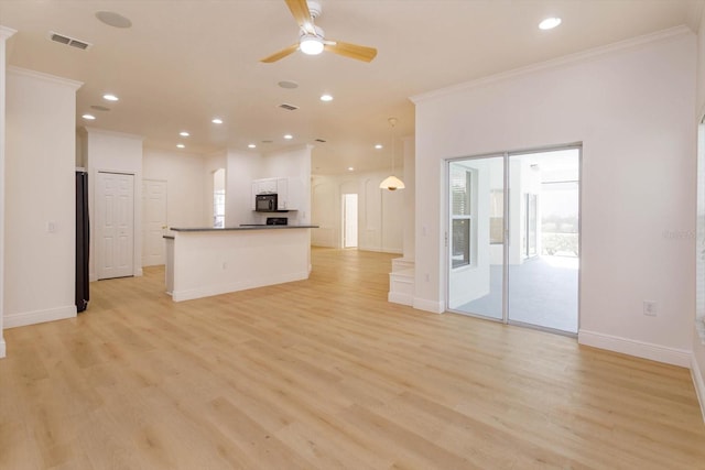 kitchen with white cabinetry, ornamental molding, light wood-type flooring, and black appliances