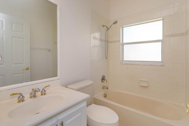 full bathroom with vanity, tiled shower / bath combo, and toilet