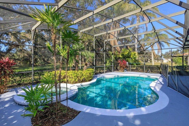 view of pool featuring a lanai, a patio area, and an in ground hot tub