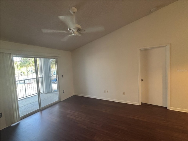 empty room featuring dark hardwood / wood-style flooring, vaulted ceiling, and ceiling fan