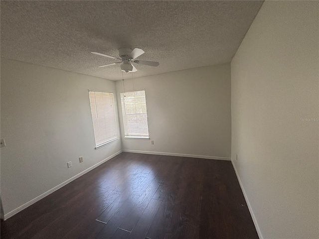 spare room featuring a textured ceiling, ceiling fan, and dark wood-type flooring